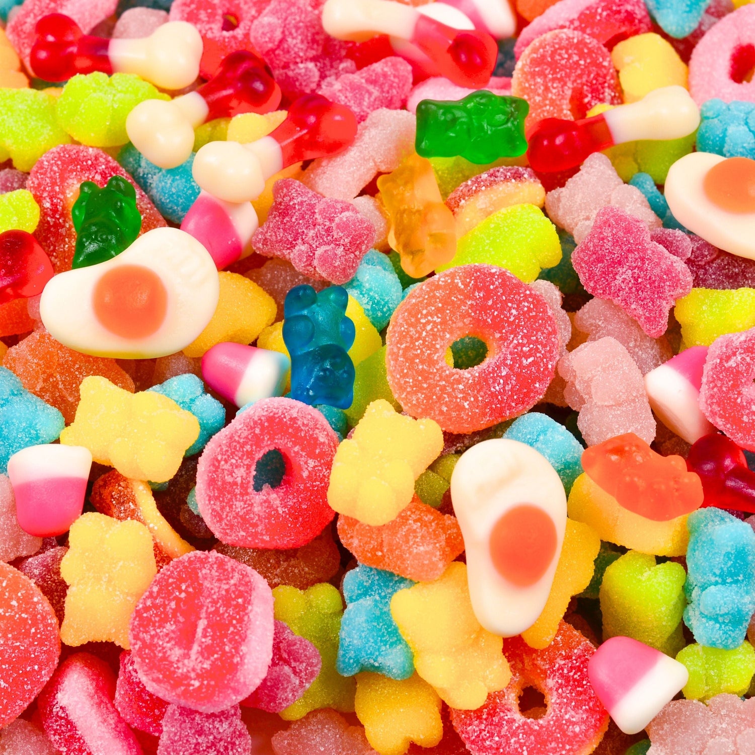 Assortment of colorful candies, including gummy rings, stars, and various shapes, all in vibrant colors.