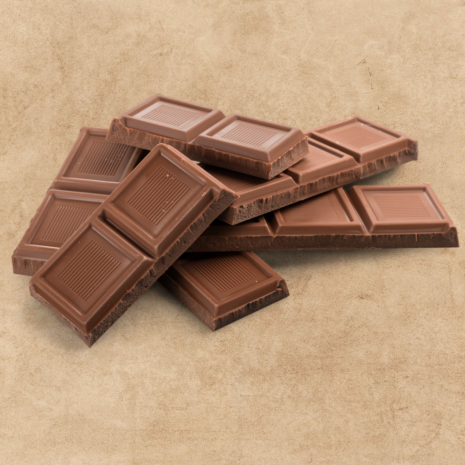 Broken milk chocolate bars placed on a brown surface.